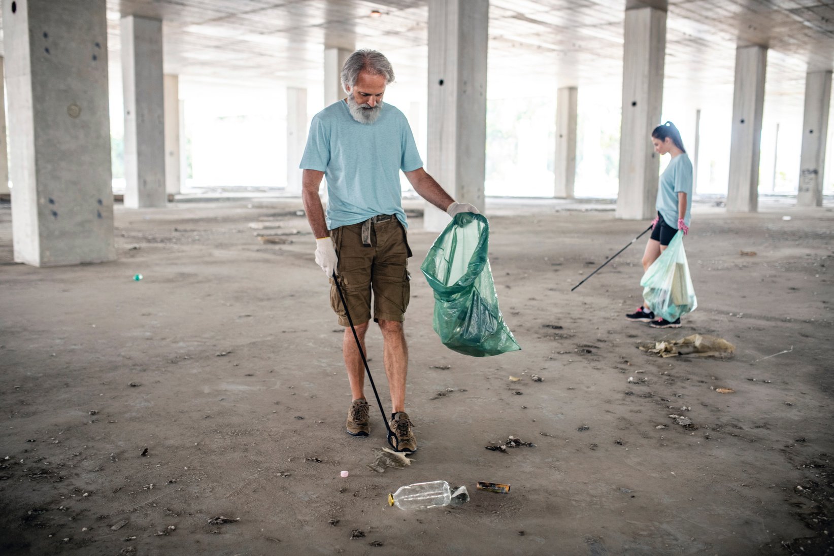 Male Member of Community Outreach Cleaning Up Outdoor Garage